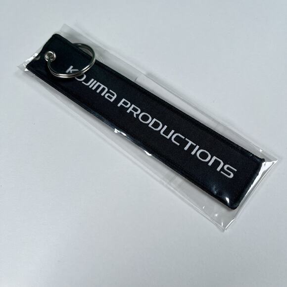 Kojima Productions Flight Tab / Strap Keychain New Death Stranding 2 Pop Up - Picture 1 of 3
